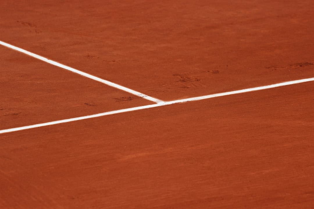 Marcações brancas sobre quadra de tênis de saibro